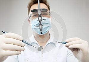 Dentist with mirror and hook - closeup