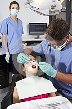 Dentist And Nurse Giving Girl Check Up