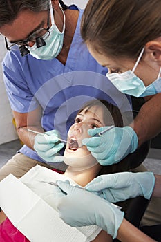 Dentist And Nurse Giving Girl Check Up