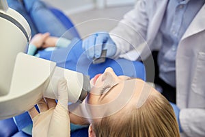 Dentist and patient with dental x-ray machine