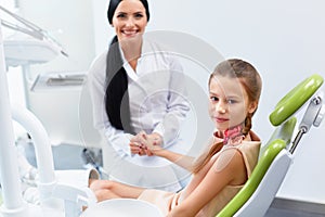Dentist and Patient in Dentist Office. Child in the Dental Chair