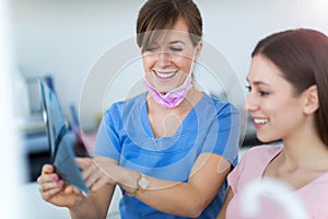 Dentist and patient in dentist office photo