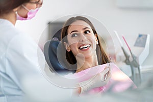 Dentist and patient in dentist office photo