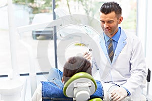 Dentist and Patient in Dentist Office. Young Man in the Dental C