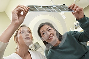 Dentist And patient Examining X-Ray