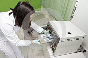 Dentist Places Medical Autoclave For Sterilising Surgical