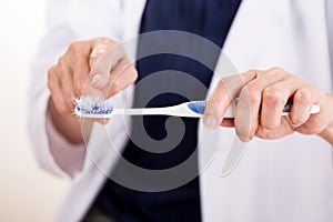 Dentist pointing at old worn out toothbrush bristle