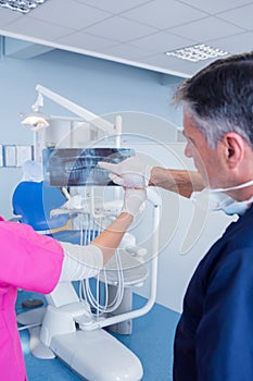 Dentist pointing something at x-ray