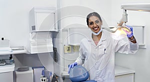 Dentist, portrait and woman by xray machine with smile for mouth care, dental health and service. Medical professional