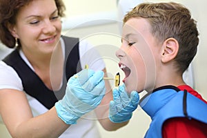 Dentist prepares boy for tooth x-ray image photo