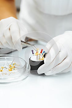 The dentist prepares needles to remove the nerve in the tooth