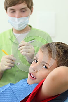 Dentist prepares to treat teeth of boy