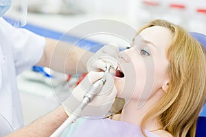 dentist procedure of teeth polishing with cleaning from