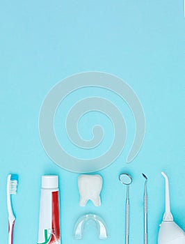 Dentist Professional tools medical equipment toothbrush, toothpaste and Tooth model on Blue background. Dental Hygiene and Health