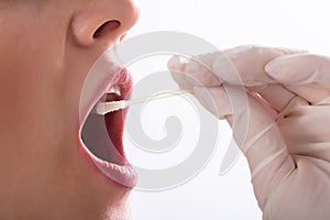 Dentist Taking Saliva Test Of A Patient