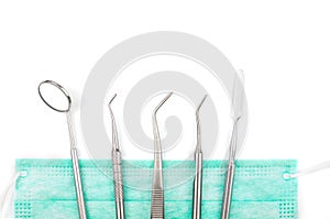 Dentist`s tools and mask on white background.