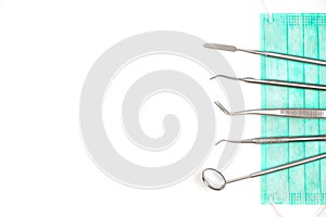 Dentist`s tools and mask on white background.