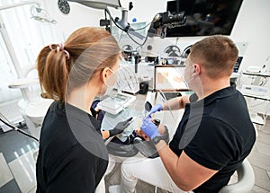 Dentist scanning patient's teeth with modern machine for intraoral scanning.