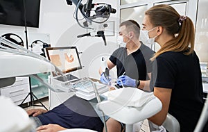 Dentist scanning patient's teeth with modern machine for intraoral scanning.