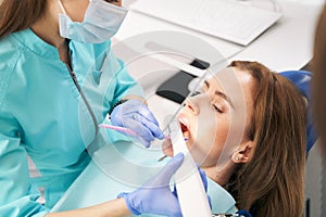 Dentist scanning woman teeth with dental 3D scanner