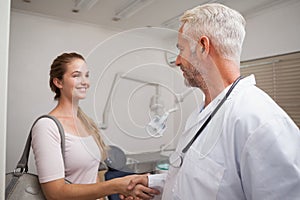 Dentist shaking hands with his patient