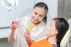 Dentist show dentures to a patient