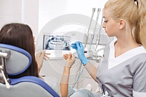 Dentist showing X-ray image to patient