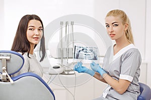 Dentist showing X-ray image to patient