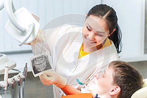 Dentist showing x-ray to a patient