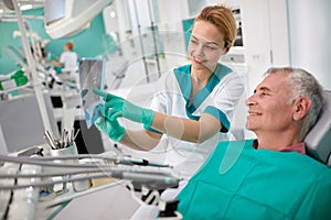 Dentist showing teeth problem on dental X-ray