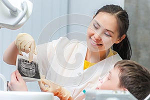 Dentist showing x-ray to a patient photo