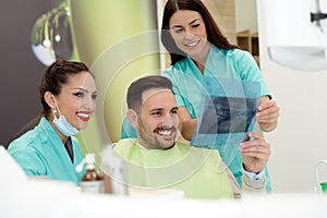 Dentist shows a patient x-ray image