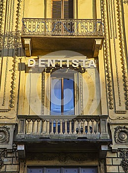 Dentist signboard on a balcony of a typical European building