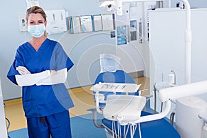 Dentist smiling at camera with arms crossed