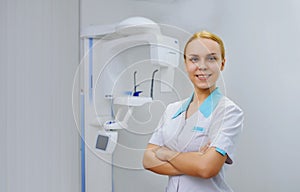 Dentist smiling in panoramic teeth x ray office