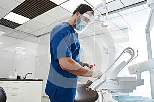Dentist sterilize the medical equipment inside a dental clinic photo
