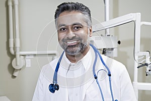 Dentist With Stethoscope In Clinic