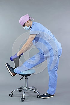 Dentist stretching body at the chair
