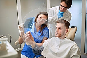 Dentist study patientâ€™s X-ray of teeth