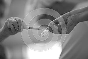 A dentist takes a disposable swab with tweezers