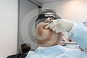 Dentist taking teeth imprint or impression of patient in dental clinic