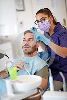 Dentist talk with patient about his teeth