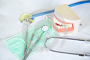 Dentist tools with bamboo toothbrush dentures dentistry instruments and dental hygienist checkup concept with teeth model and