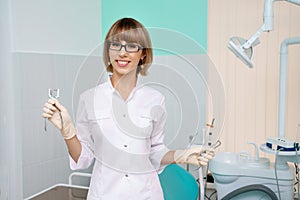 Dentist with tools in hand in the dental office