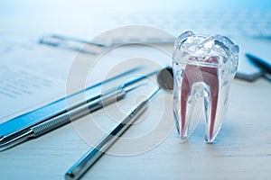 Dentist tools, tooth model on dentist table with computer keyboard. and notebook Dental probe, mirror and explorer, with copy spac