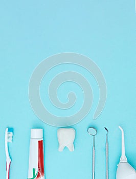 Dentist tools toothbrush, toothpaste and Tooth model on Blue background.. Dental equipment. Dental Care conceptual image