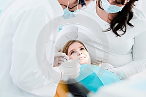 Dentist trearing child in his surgery