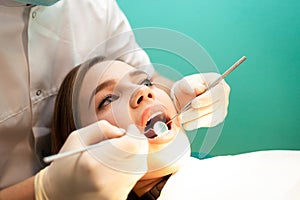 Dentist treats the woman teeth close-up. Young woman visited a dentist.