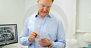 Dentist using mobile phone