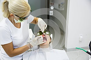 Dentist using a modern diode dental laser photo